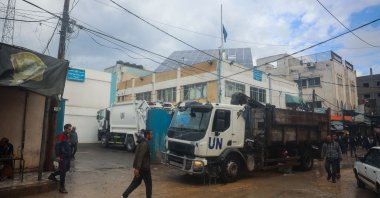 Palestinians walk in front of an UNRWA office in Bureij in the central Gaza Strip, days into a cease-fire deal between Israel and the Palestinian resistance group Hamas, Palestine, Jan. 23, 2025. (AFP Photo)