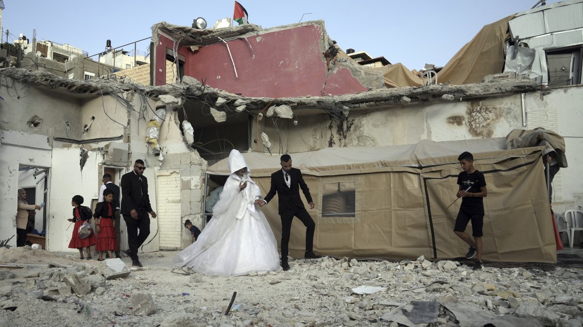 Palestinian bride Rabiha al-Rajby and groom Mohyeldin Nasrallah start their wedding ceremony near the ruins of al-Rajby&#039;s home in the East Jerusalem neighborhood of Silwan, occupied Palestine, June 11, 2022. (AP Photo)