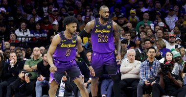Bronny James (R) stands by LeBron James of the Los Angeles Lakers during the second half against the Philadelphia 76ers at the Wells Fargo Center, Philadelphia, Pennsylvania, U.S., Jan. 28, 2025. (AFP Photo)