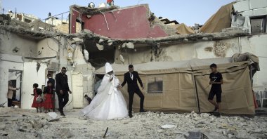 Palestinian bride Rabiha al-Rajby and groom Mohyeldin Nasrallah start their wedding ceremony near the ruins of al-Rajby&#039;s home in the East Jerusalem neighborhood of Silwan, occupied Palestine, June 11, 2022. (AP Photo)