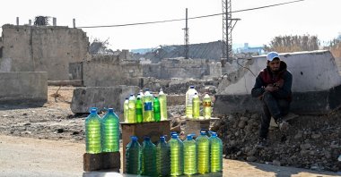 A gasoline vendor sits on the side of the road, Damascus, Syria, Jan. 14, 2025. (AFP Photo)