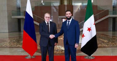 Syria's new leader Ahmed al-Sharaa (R) and Russia's Deputy Foreign Minister Mikhail Bogdanov posing for a picture during their meeting in Damascus, Syria, Jan. 29, 2025. ()