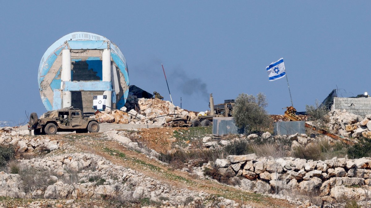 This picture, taken from a position in northern Israel near the border with Lebanon shows Israeli military vehicles in the southern Lebanese village of Marwahin on Jan. 29, 2025. (AFP Photo)