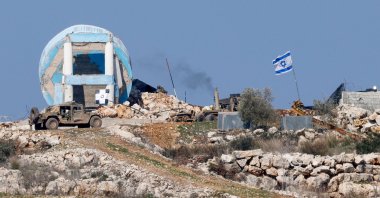 This picture, taken from a position in northern Israel near the border with Lebanon shows Israeli military vehicles in the southern Lebanese village of Marwahin on Jan. 29, 2025. (AFP Photo)