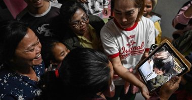 Wiwwaeo Sriaoun (L), the mother of Thai farm worker Watchara Sriaoun who was held hostage in Gaza, reacts as she receives an image of her son (R) being released, at her home in rural northeast Udon Thani province, Thailand, Jan. 30, 2025. (AFP Photo)