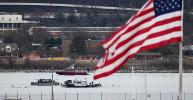 A police boat gathers wreckage along the Potomac River after the collision, near Washington, D.C., Jan. 30, 2025. (AFP Photo)
