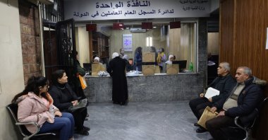People wait at a government building in Damascus suburb, Syria Jan. 8, 2025. (Reuters Photo)