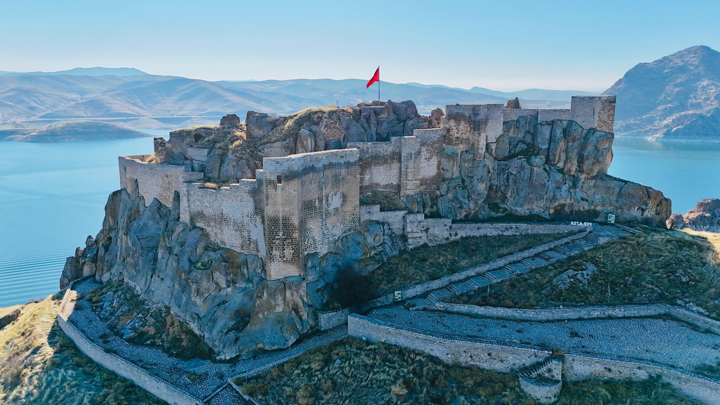 An aerial view of Pertek Castle as its lower gate reemerges from Keban Dam Lake, Tunceli, Türkiye, Feb. 2, 2025. (DHA Photo)