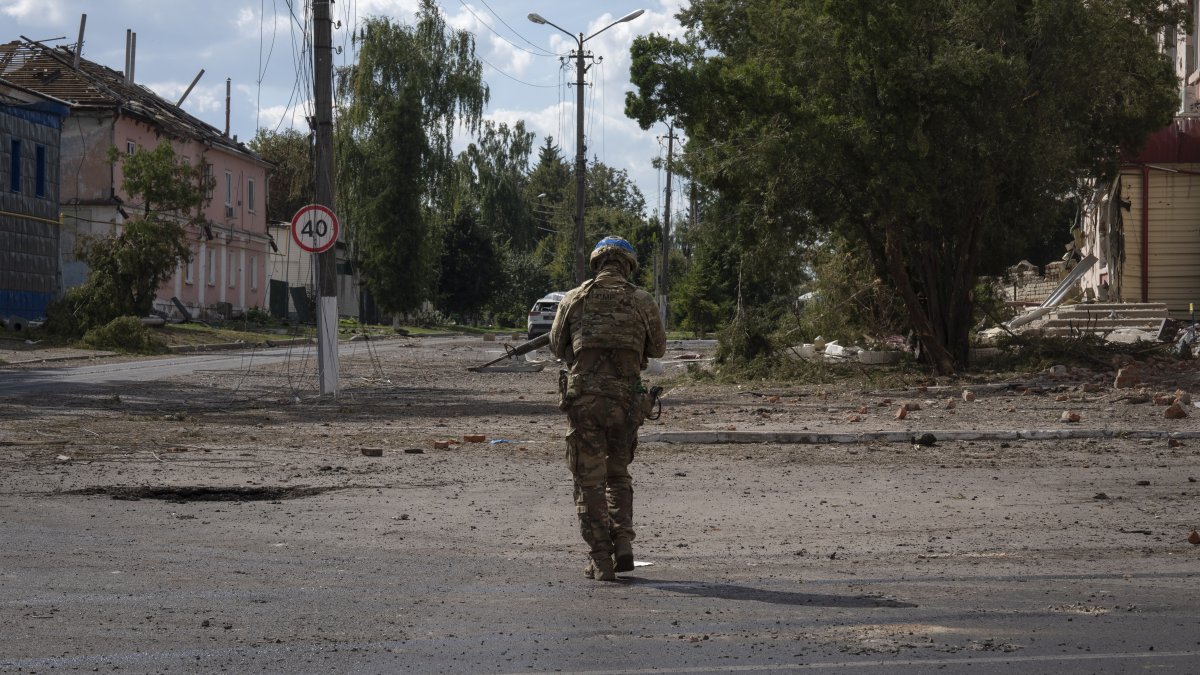 A Ukrainian soldier walks past at a city center in Sudzha, Kursk region, Russia, Aug. 16, 2024. (AP Photo)