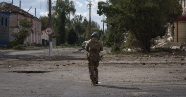 A Ukrainian soldier walks past at a city center in Sudzha, Kursk region, Russia, Aug. 16, 2024. (AP Photo)