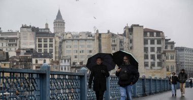People walk over Galata Bridge, Istanbul, Türkiye, Jan. 15, 2025. (AA Photo)