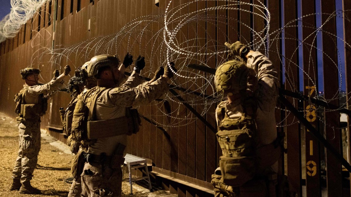 This picture provided by the U.S. Defense Department shows U.S. Marines with 1st Combat Engineer Battalion, 1st Marine Division, installing concertina wire along the southern border with Mexico near San Ysidro, California, Jan. 25, 2025. (US Department of Defense / Sgt. Kyle Chan via AFP)