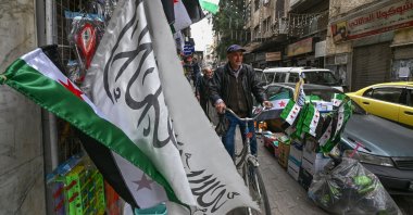 A man ride a bicycle on a sidewalk in Damascus, Syria, Jan. 26, 2025. (AFP Photo)
