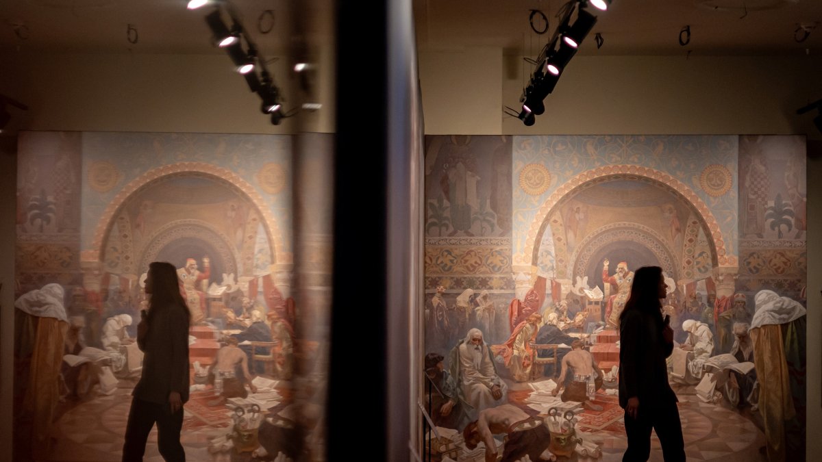 A visitor looks at artworks by Czech artist Alphonse Mucha displayed during a press preview of the new Mucha Museum in Prague, Czechia, Jan. 3, 2025. (EPA Photo)