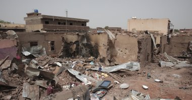 A man walks by a house hit in recent fighting in Khartoum, Sudan, April 25, 2023. (AP Photo)