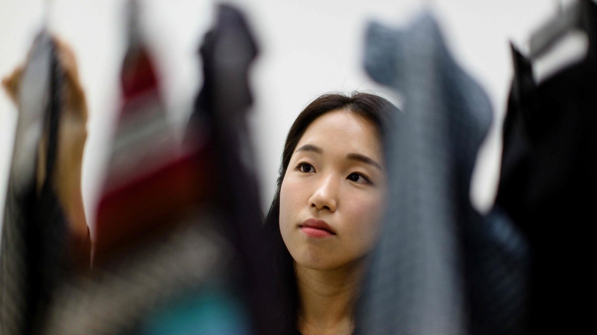In this photograph, South Korean climate activist Lee So-yeon, who has not bought any new clothes for the past six years, looks at a selection of her clothes, during an interview, Seoul, South Korea, July 23, 2024. (AFP Photo)