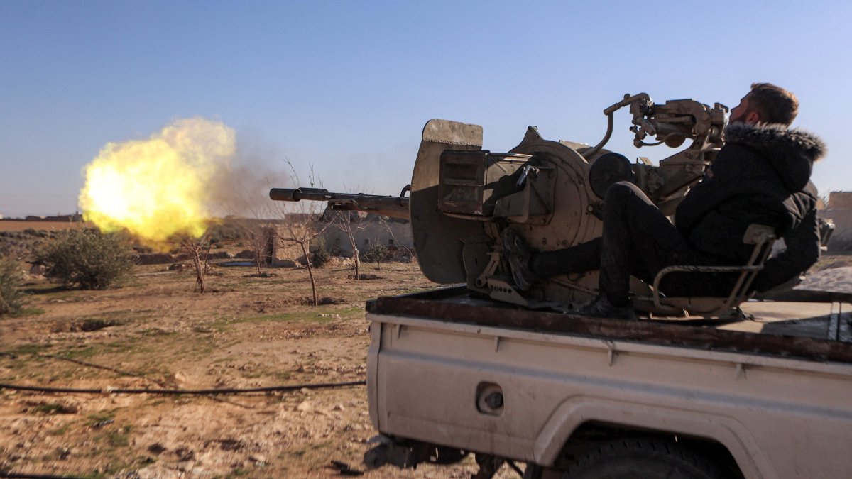 A member of the Syrian National Army (SNA) fires from a turret mounted in the back of a "technical" pickup truck deployed at a position near Tishrin Dam in the vicinity of Manbij, Syria, Jan. 10, 2025. (AFP Photo)