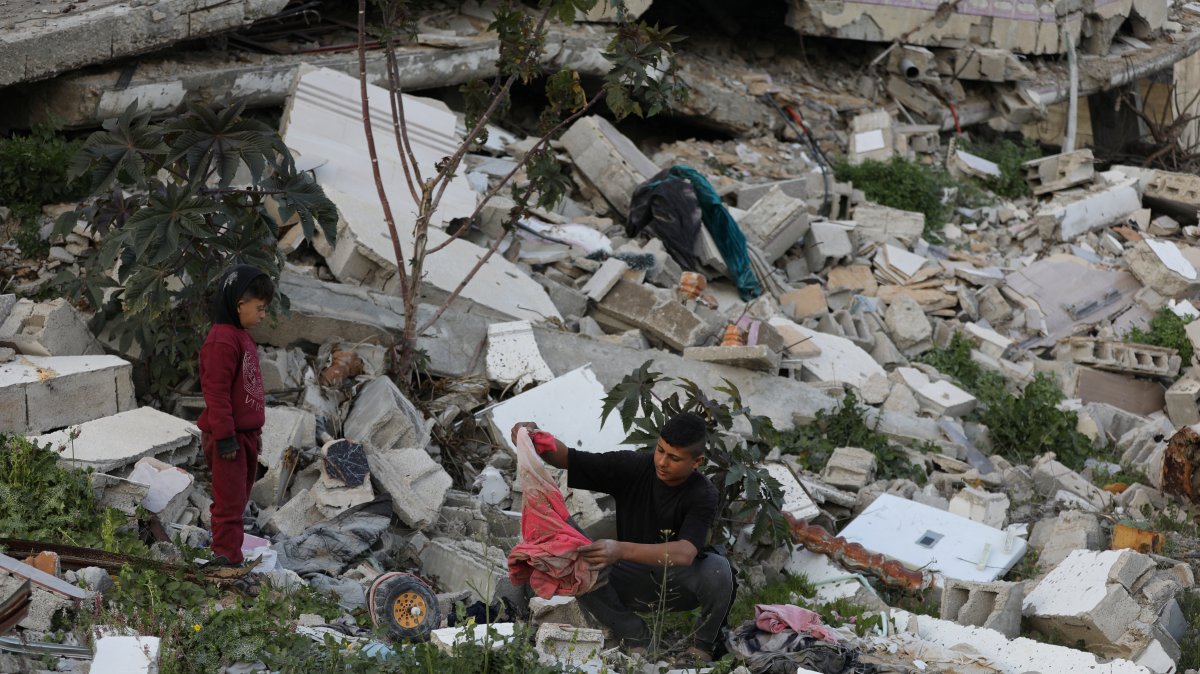 Naseem, 22, and Mohammed, 5, who were displaced with their family to the southern part of Gaza at Israel&#039;s order during the war, search for their belongings amongst the rubble of their house destroyed by Israel, amid a cease-fire, in Jabalia, northern Gaza Strip, Jan. 30, 2025. (Reuters Photo)