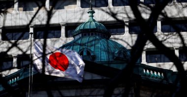 Japanese national flag hoisted atop the Bank of Japan headquarters is seen through trees in Tokyo, Japan, Jan. 23, 2025. (Reuters Photo)