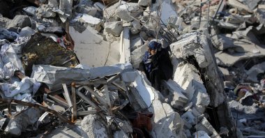 A Palestinian woman sits on the rubble of houses and buildings destroyed during the Israeli offensive, in Jabalia refugee camp, northern Gaza Strip, Palestine, Jan. 29, 2025. (Reuters Photo)