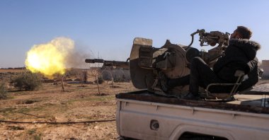 A member of the Syrian National Army (SNA) fires from a turret mounted in the back of a "technical" pickup truck deployed at a position near Tishrin Dam in the vicinity of Manbij, Syria, Jan. 10, 2025. (AFP Photo)