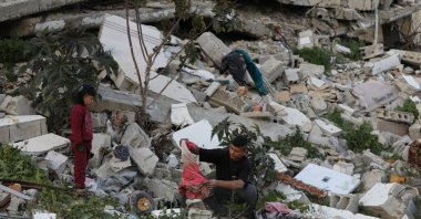 Naseem, 22, and Mohammed, 5, who were displaced with their family to the southern part of Gaza at Israel's order during the war, search for their belongings amongst the rubble of their house destroyed by Israel, amid a cease-fire, in Jabalia, northern Gaza Strip, Jan. 30, 2025. (Reuters Photo)