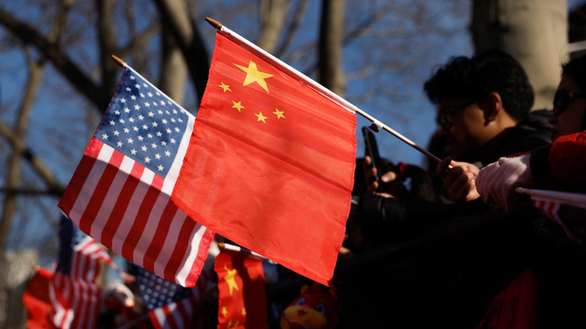 People hold U.S. and China flags as they attend a celebration of the Lunar New Year, in the Chinatown section of Manhattan, New York City, U.S., Jan. 29, 2025. (Reuters Photo)