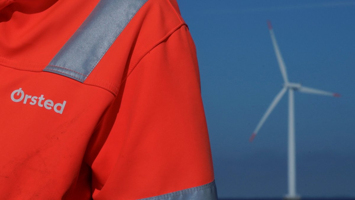 The logo for Orsted can be seen on the jacket worn by an employee close to an offshore wind farm near Nysted, Denmark, Sept. 4, 2023. (Reuters Photo)
