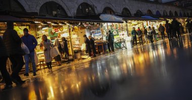 People buy food outside a historical market at the Eminönü commercial area, Istanbul, Türkiye, Dec. 26, 2024. (AP Photo)