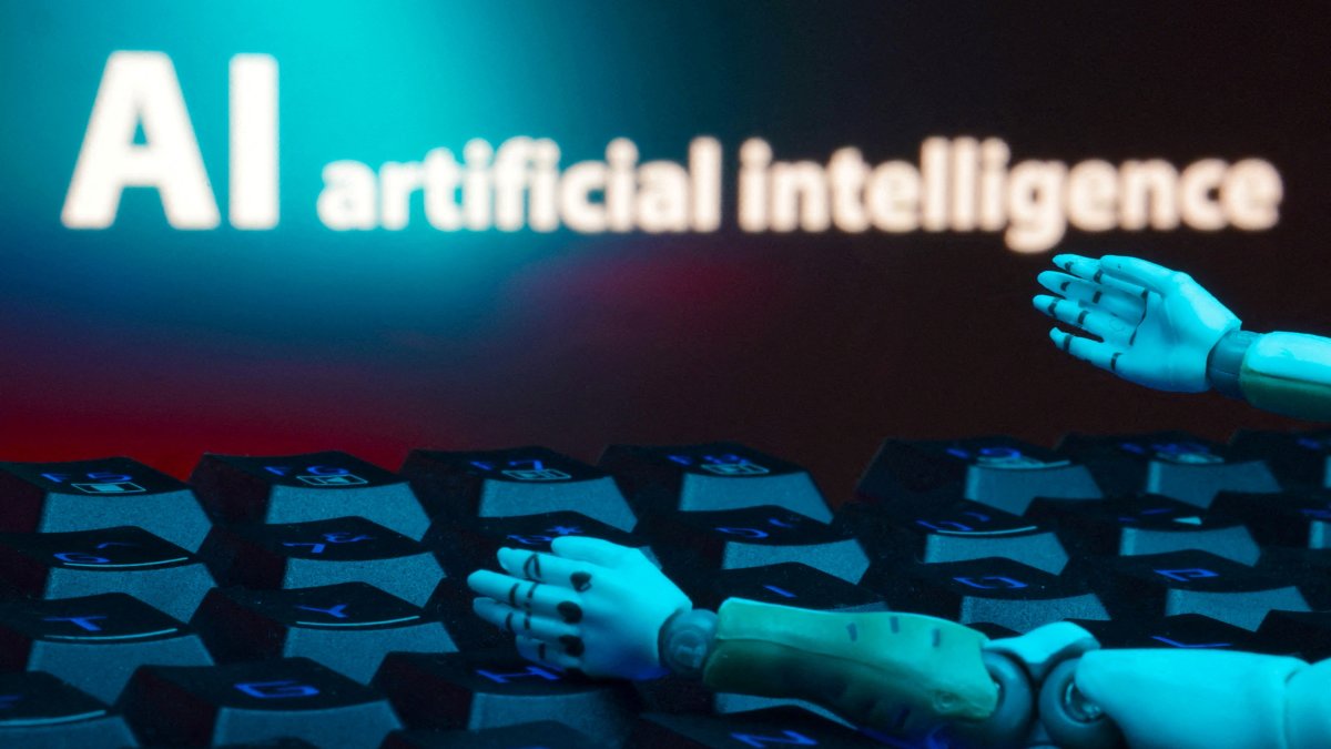 A message reading &quot;AI artificial intelligence,&quot; a keyboard and robot hands are seen in this illustration taken on Jan. 27, 2025. (Reuters Photo)