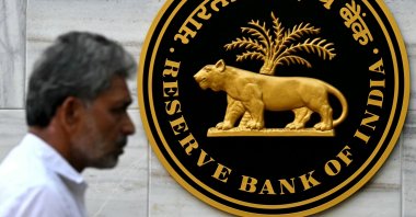 A pedestrian walks past the Reserve Bank of India (RBI) logo outside its headquarters in Mumbai, India, Feb. 7, 2025. (AFP Photo)