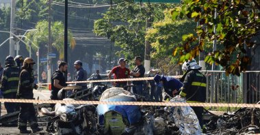 Emergency personnel work at the site where a small plane crashed into vehicles on Marques de Sao Vicente Avenue in Sao Paulo, Brazil, Feb. 7, 2025. (Reuters Photo=