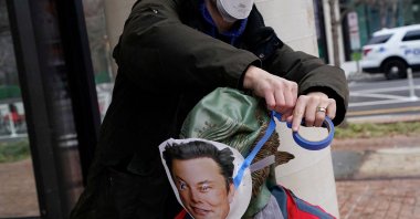 A demonstrator in a swamp monster costume has an Elon Musk mask attached to them at a protest by the Consumer Financial Protection Bureau (CFPB) building, Washington, U.S., Feb. 8, 2025. (Reuters Photo)