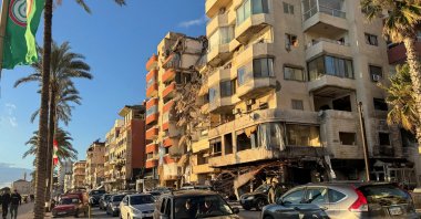 Cars drive past a damaged building near the Corniche, Tyre, Lebanon, Jan. 24, 2025. (Reuters Photo)