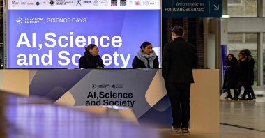 People walk down the stairs during an AI Action Summit, Paris, France, Feb. 7, 2025. (AFP Photo)