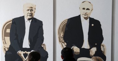 Visitors stand in front of an artwork depicting U.S. President Donald Trump and Russian President Vladimir Putin at an exhibition, in Yalta, Crimea, Feb. 8, 2025. (Reuters Photo)