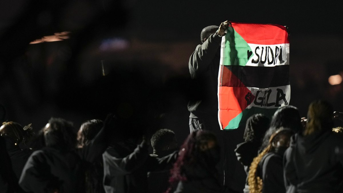 An attendee holds flags during halftime of the NFL Super Bowl 59 football game between the Kansas City Chiefs and the Philadelphia Eagles, New Orleans, U.S., Feb. 9, 2025. (AP Photo)