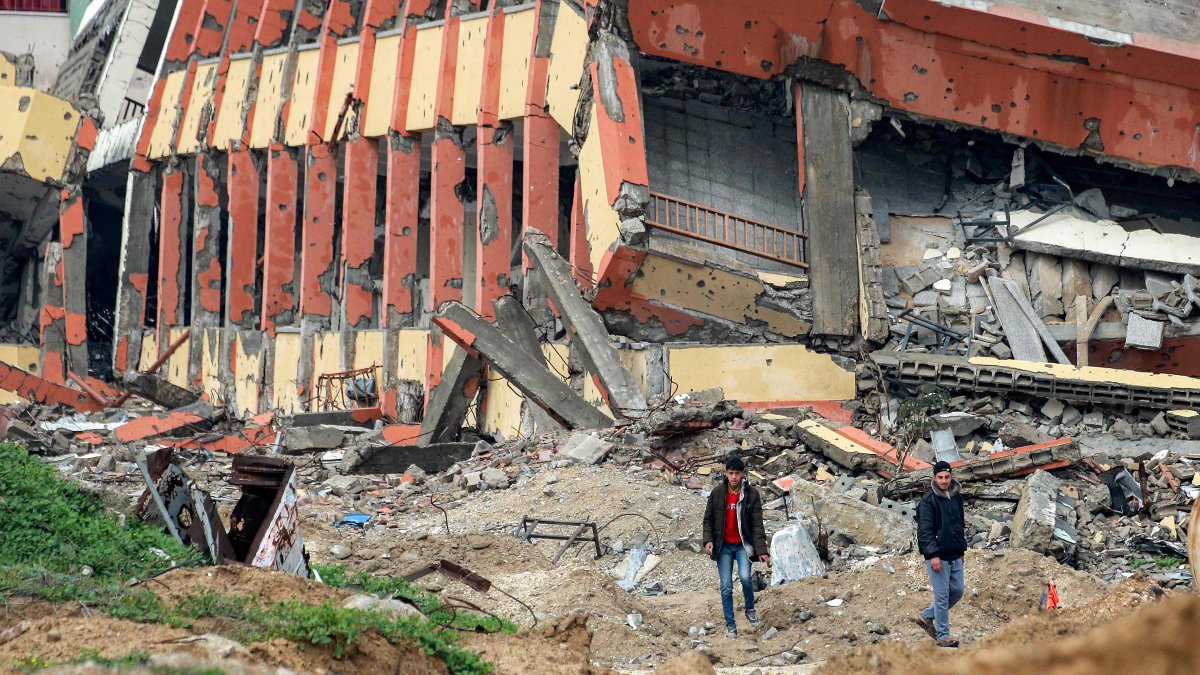 Palestinian youths walk past a destroyed secondary school in the north of Gaza City, Palestine, Feb. 10, 2025. (AFP Photo)