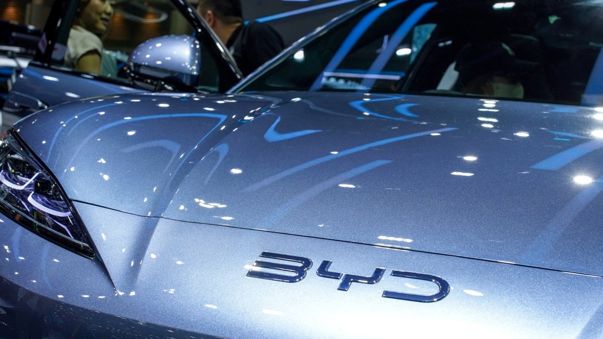 A visitor stands next to a BYD Sealion 7 EV car at the 41st Thailand International Motor Expo in Bangkok, Thailand, Nov. 29, 2024. (Reuters Photo)