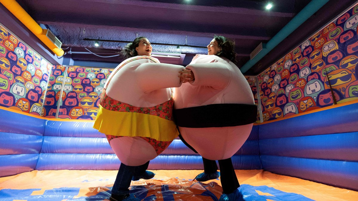 Visitors, wearing stuffed costumes, fight in the "sumo arena" at the HaHaHouse Museum of Laughter in central Zagreb, Croatia, Jan. 21, 2025. (AFP Photo)