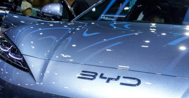 A visitor stands next to a BYD Sealion 7 EV car at the 41st Thailand International Motor Expo in Bangkok, Thailand, Nov. 29, 2024. (Reuters Photo)