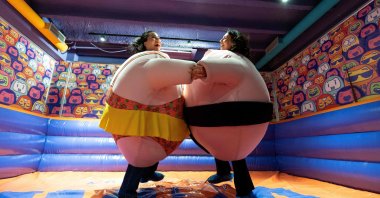Visitors, wearing stuffed costumes, fight in the &quot;sumo arena&quot; at the HaHaHouse Museum of Laughter in central Zagreb, Croatia, Jan. 21, 2025. (AFP Photo)