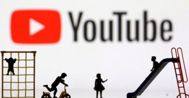 Children&#039;s playground miniatures are seen in front of a YouTube logo in this illustration taken April 4, 2023. (Reuters Photo)