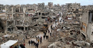 Palestinians walk past the rubble of buildings destroyed by Israeli attacks, Gaza City, Palestine, Feb. 6, 2025. (Reuters File Photo)
