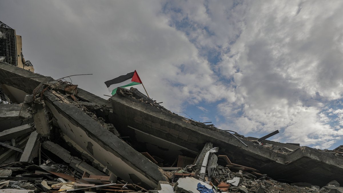A Palestinian flag flies atop the rubble of a house destroyed by Israel in the al-Zaytoun neighborhood of Gaza, Feb. 12, 2025. (EPA Photo)
