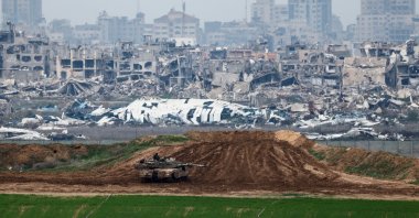 An Israeli soldier sits on a tank as he looks at the destruction, Gaza, Palestine, Feb. 11, 2025. (Reuters Photo)