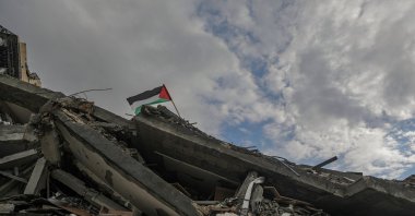 A Palestinian flag flies atop the rubble of a house destroyed by Israel in the al-Zaytoun neighborhood of Gaza, Feb. 12, 2025. (EPA Photo)
