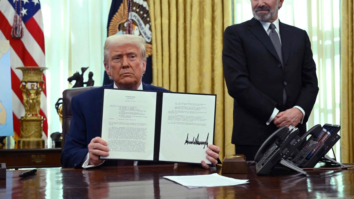 U.S. President Donald Trump displays his signature on an executive order on reciprocal tariffs in the Oval Office of the White House in Washington, D.C., U.S., Feb. 13, 2025. (AFP Photo)