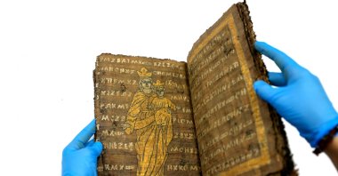 A historical manuscript is examined as part of efforts to identify counterfeit religious artifacts in Konya, Türkiye, Feb. 12, 2025. (AA Photo)