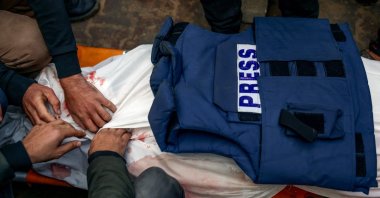 Mourners prepare for burial the body of Palestinian journalist Ahmed al-Shayah, covered with a press vest, after he was killed in an Israeli strike, Khan Younis, southern Gaza Strip, Jan. 16, 2025. (AFP Photo)